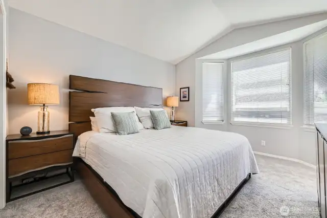 Large primary bedroom (this is a king bed) with vaulted ceilings!