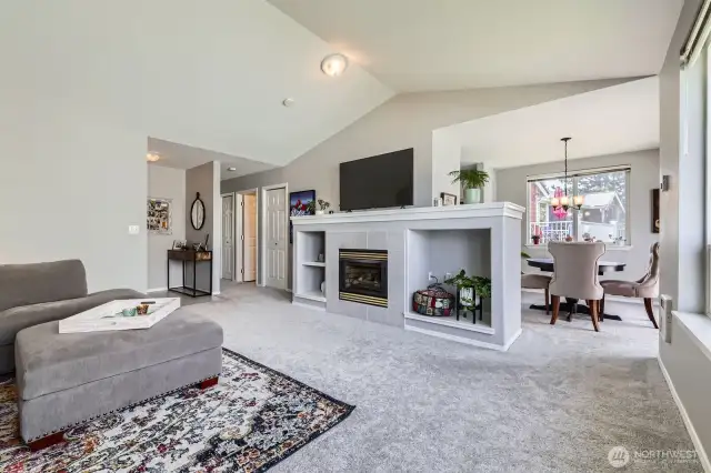 The living room is central to the condo with the dining room, kitchen & deck on one side, and bedrooms on the other.