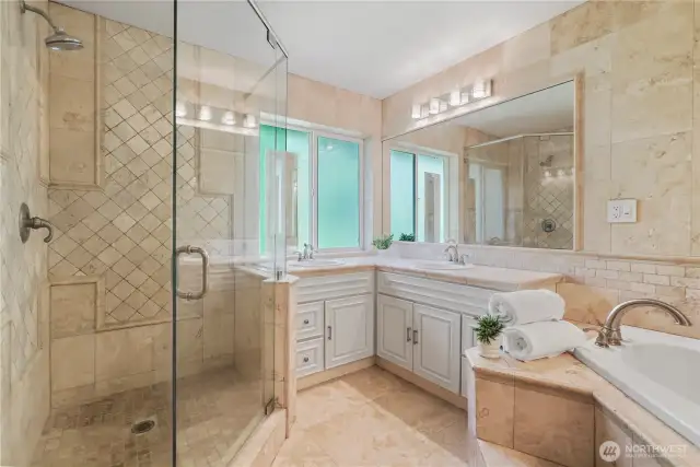 Spacious ensuite with dual vanities, walk-in shower, soaking tub, and private water closet.