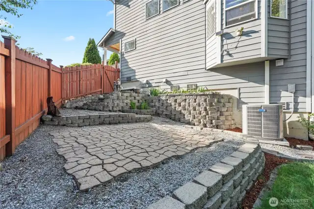 Additional seating or firepit area with pavers.