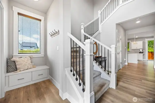 Foyer with bench and beautiful open staircase