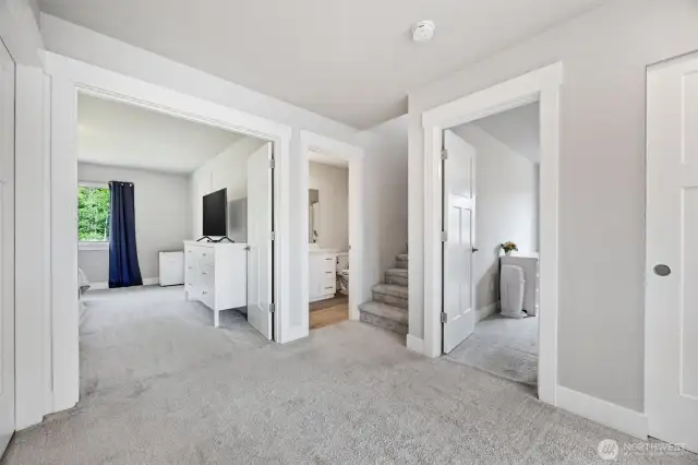 Upstairs hall way, primary bedroom thru French doors