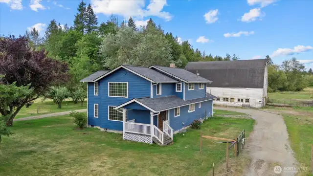 Completely fenced 10 Acres w/ a circular driveway & two gates.