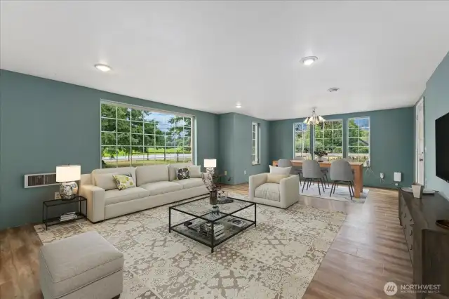 The large family & dining room welcome you into the home. Large windows & a door off to the back deck. Virtually Staged.