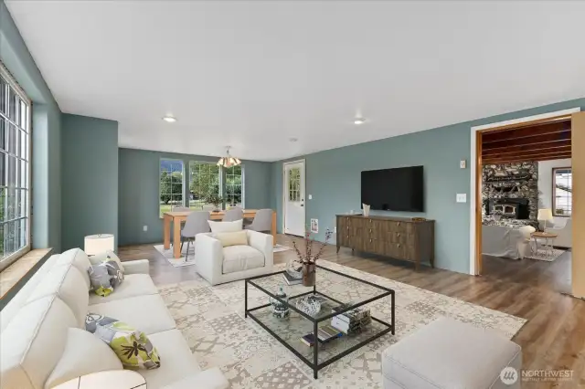Another shot of the living & dining area. There is a Lg door that leads into the Kitchen & Family room. Virtually Staged.