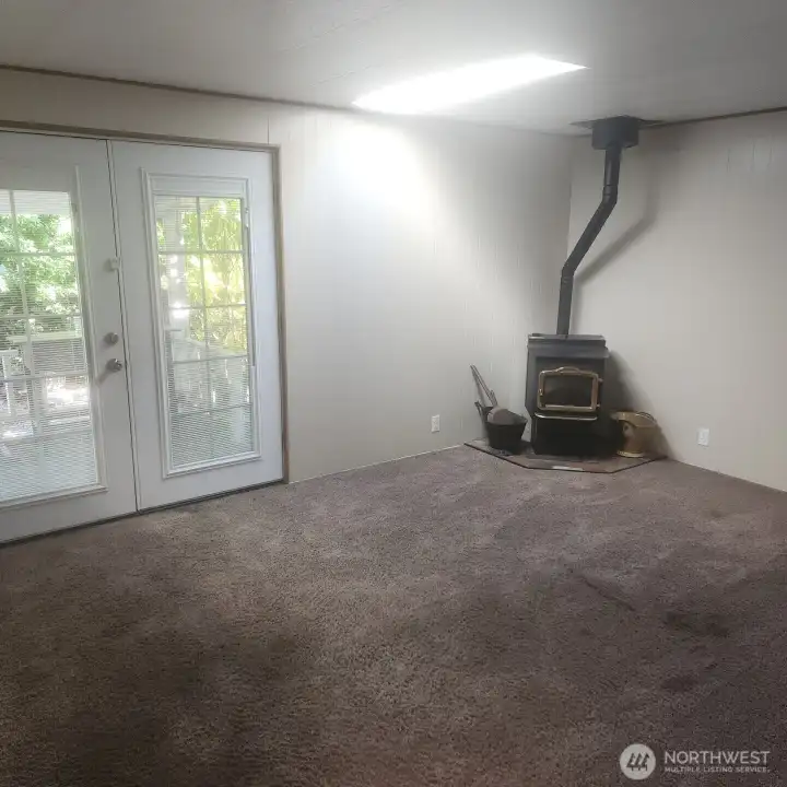 Family room with second wood stove and french doors to front porch