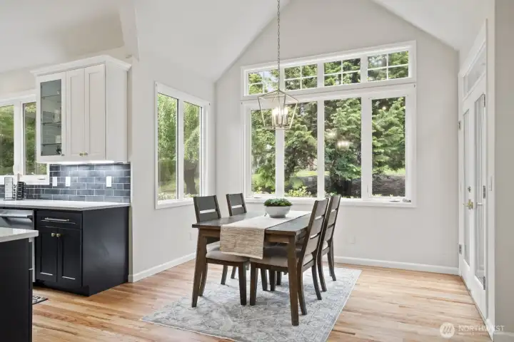 Informal dining area with French doors to the sunroom and backyard.