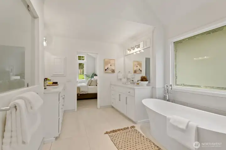 Large free standing soaking tub with privacy glass.