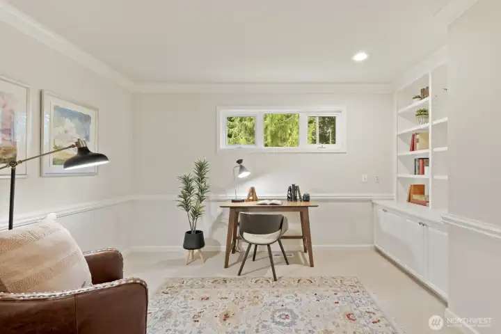 The office or study is upstairs through French doors with bookshelves, cabinets, chair rail and crown molding.
