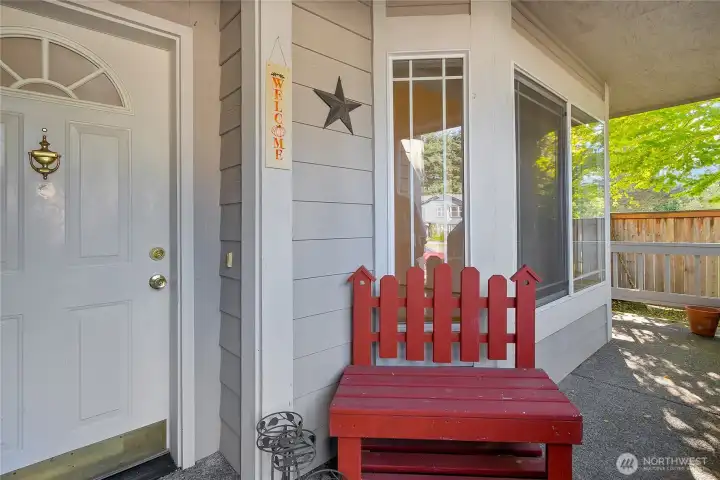 nice and cozy covered front porch, perfect for a bench, or?