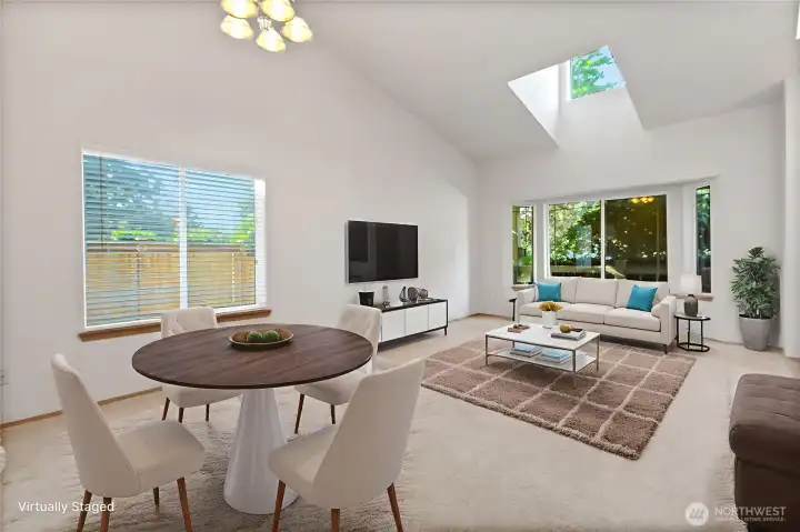 As you enter through the front door, this super sized room offers living and dining room areas. The skylight brings in lots of added light.
