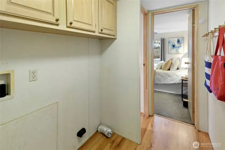 Laundry Area with cabinets above.