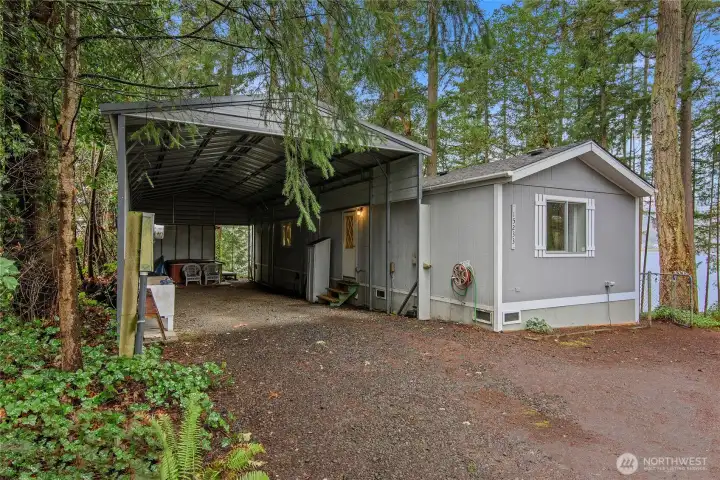 Huge Industrial Carport next to the back of the house.  Back door opens to the carport.