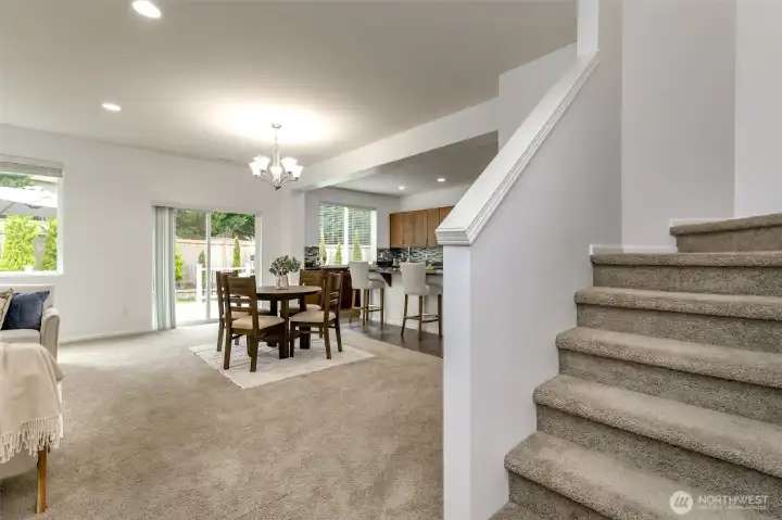 As you come through the entry and pass the den and full bath it opens to the staircase on the right and leads to the livingroom, dining room and kitchen.