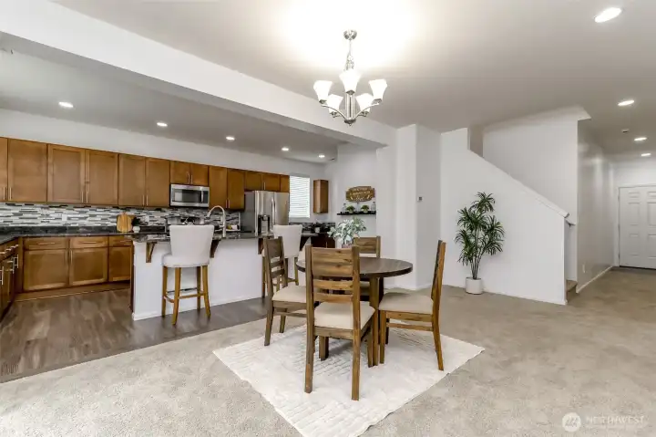 From this angle you can see the front door, staircase and see into the spacious kitchen with tons of cabinetry and storage.