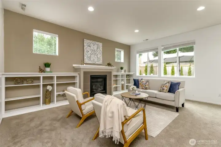 Built in book shelves flank the gas fireplace. The windows overlook the composite deck and backyard.