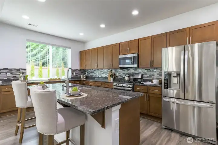 Stunning kitchen with an abundance of cabinets, storage and countertops.