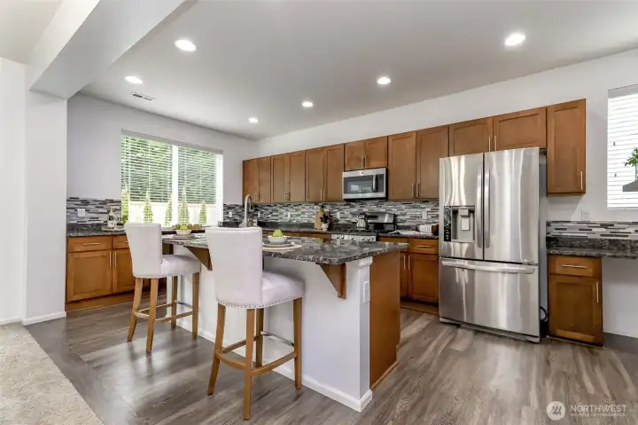 The kitchen island is spacious enough for 3- 4 barstools.
