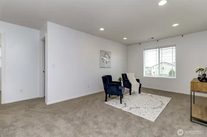 To the right of the loft is an extra bedroom and to the left is another extra bedroom. All three of these rooms face the front of the house / street.