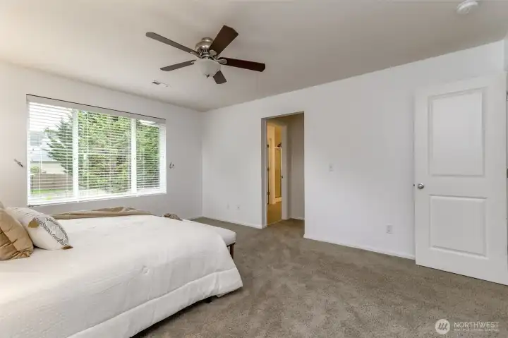 This angle of the primary bedroom faces the primary bathroom to the left and to the right of it is the walk in closet.