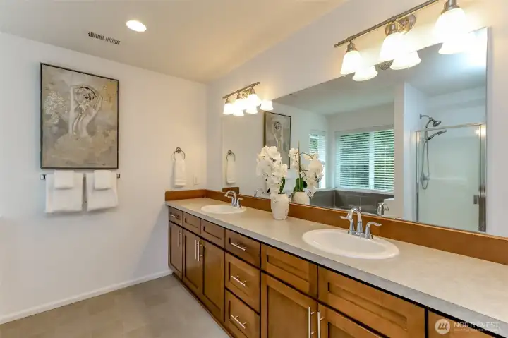 Primary bathroom with long vanity and double sinks.