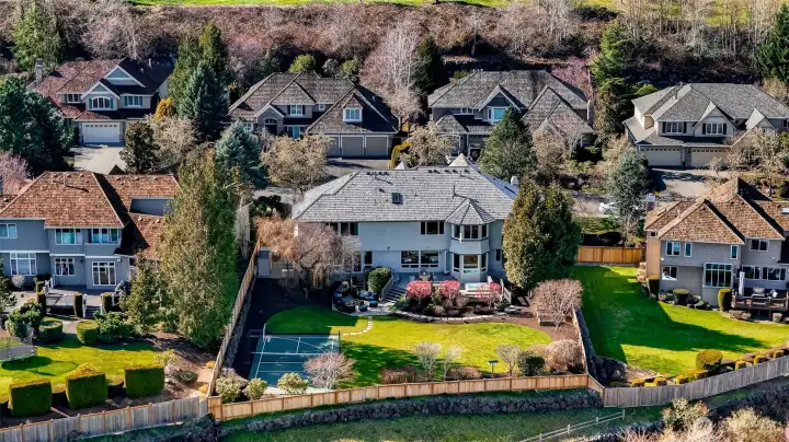 Large fenced yard with sports court.