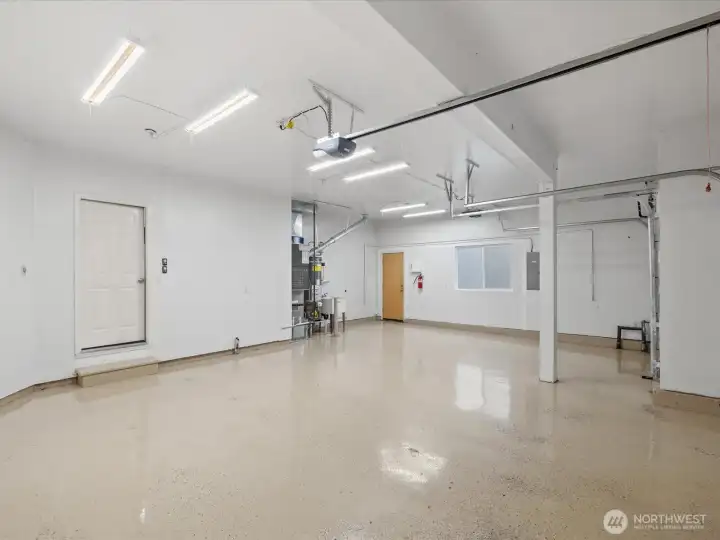 Huge three car garage with durable epoxy floors.