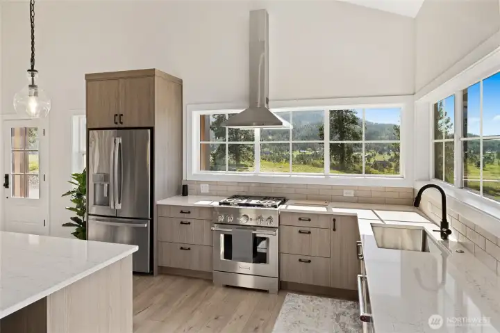 Stunning kitchen with like-new appliances and abundant windows that fill the space with natural light.