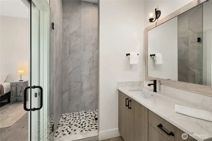 Primary bathroom featuring a beautifully tiled shower.