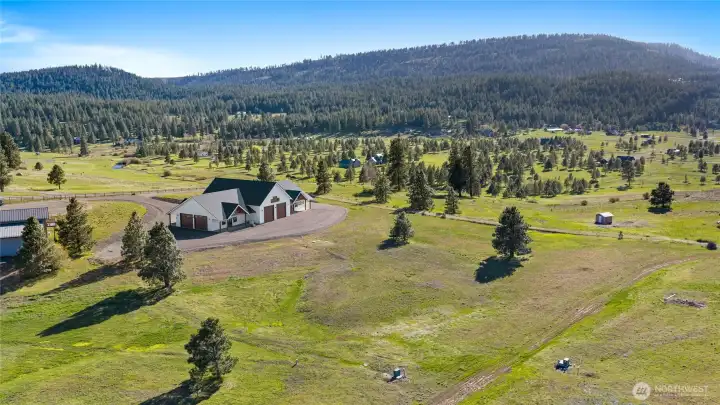 Rear view of the building, offering ample space for future development and showcasing beautiful surrounding views.