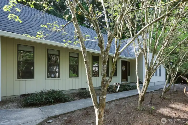 The row of trees leading to the front door are Flowering Dogwoods--STUNNING blooms every spring/summer--they are just beginning to sprout in this photo but will be amazing before long!