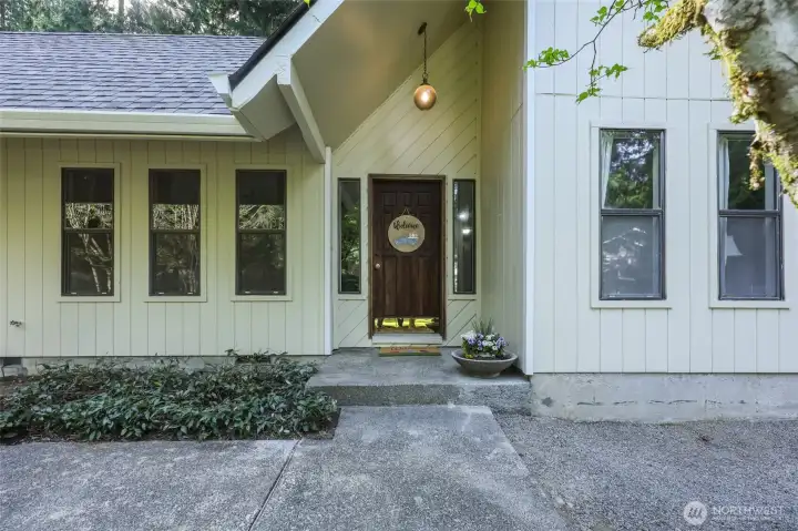 Vaulted porch is stylish and inviting, while new roof and gutters provide great protection and peace of mind.
