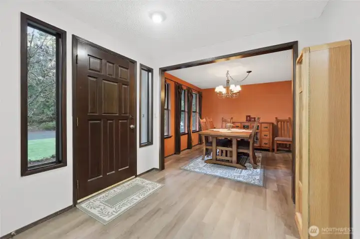 Wide entry through solid wood door welcomes all! Side-light windows bring in the natural light.