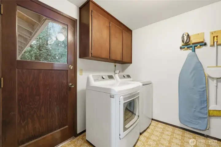 From the other side of the kitchen you'll see the garage door, as well as one of two handy entry points to the laundry room.