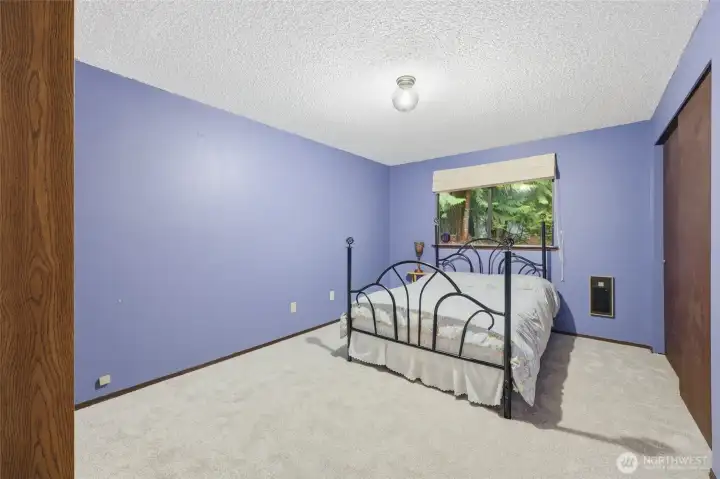 Bedroom #2, with closet on right and green views out the side. New carpet, as well!