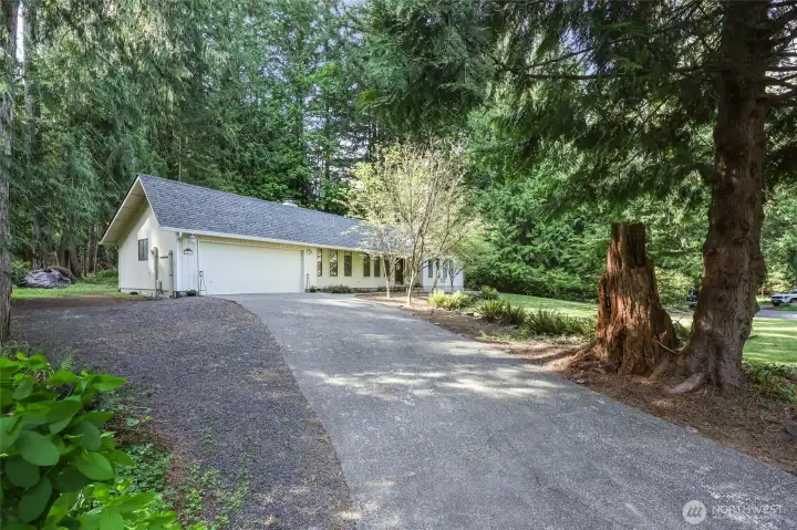Long driveway provides parking for many and sets the house up a gentle slope, away from the street.