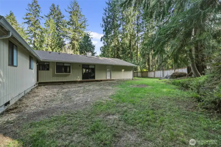Room in the private backyard for a potential deck, for enjoying the natural surroundings.