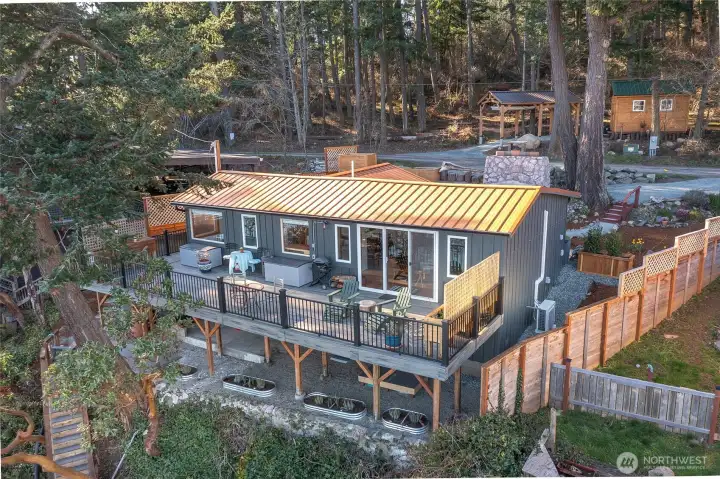 The listing includes the waterfront cottage and an additional parcel with a carport and shop.