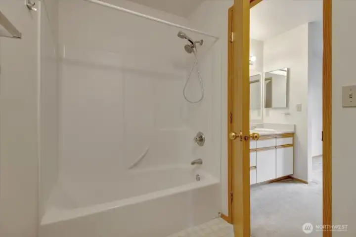 Full tub and shower in primary bath separate from sink and closet