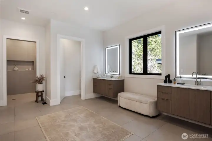 Primary bedroom ensuite bath with heated tile floors and large walk in closet