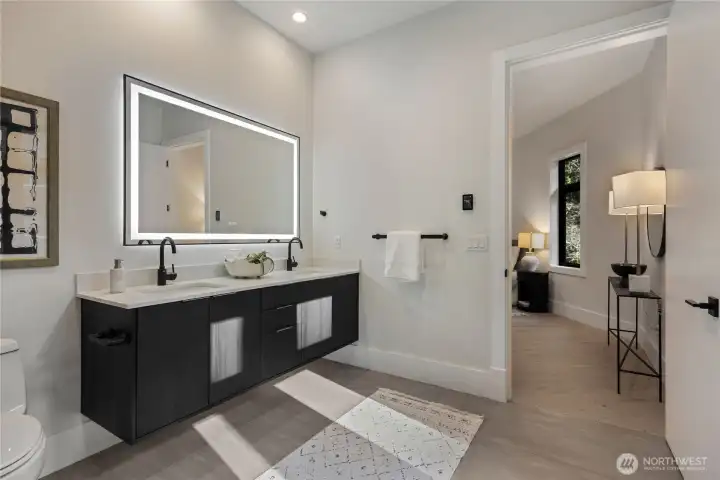 Heated tile floors and double sinks in main floor guest bath