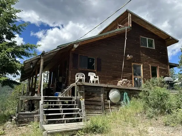 Stairs leading to front deck and front doors.