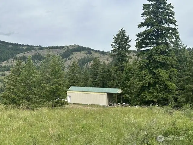 View of the garage and carport from atop the mountain. The National Forest is in the background with your own private gated access.