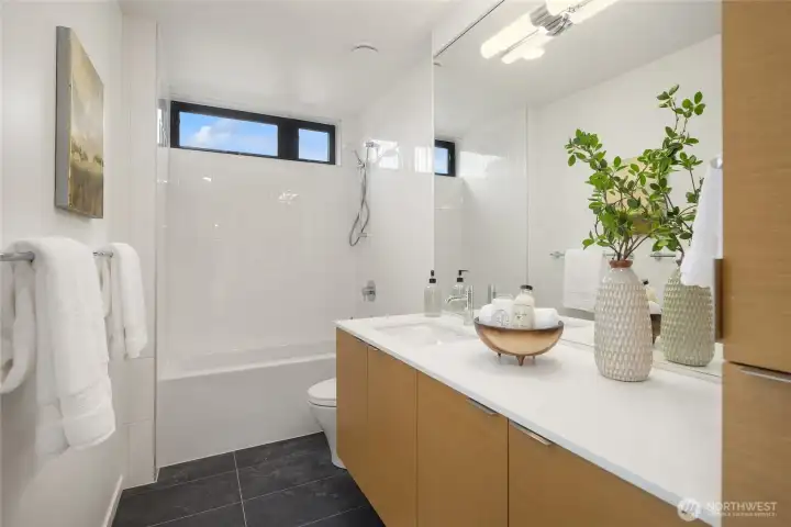 The full bath upstairs maintains the same consistent level of luxury and features a tub for soaking and relaxing after a long day, providing a luxurious and rejuvenating space. The full bath upstairs maintains the same consistent level of luxury and features a tub for soaking and relaxing after a long day, providing a luxurious and rejuvenating space.