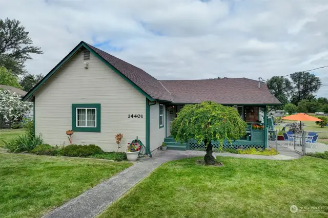 Beautifully manicured yard with mature landscaping all around.