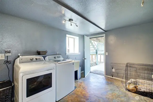 Utility/mud room leads to the lower level patio.