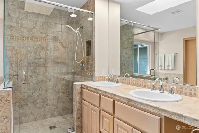 Walk-in tile shower, double sinks and a tub