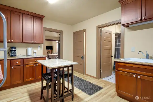 A view of the laundry room & Full Bath off the kitchen in Unit B.