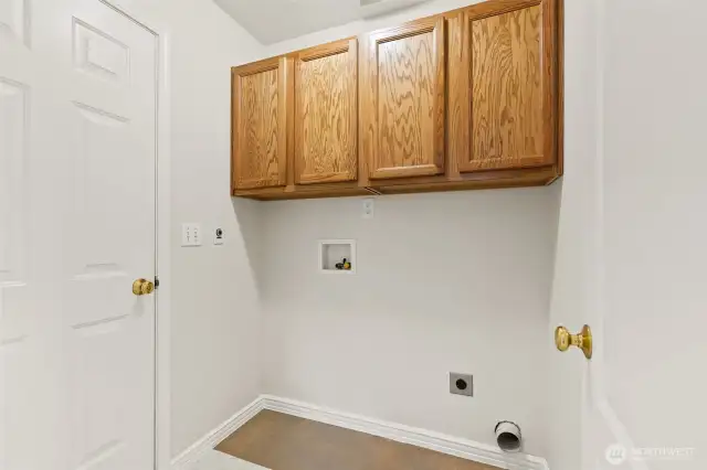 Washer/dryer, leads to garage.