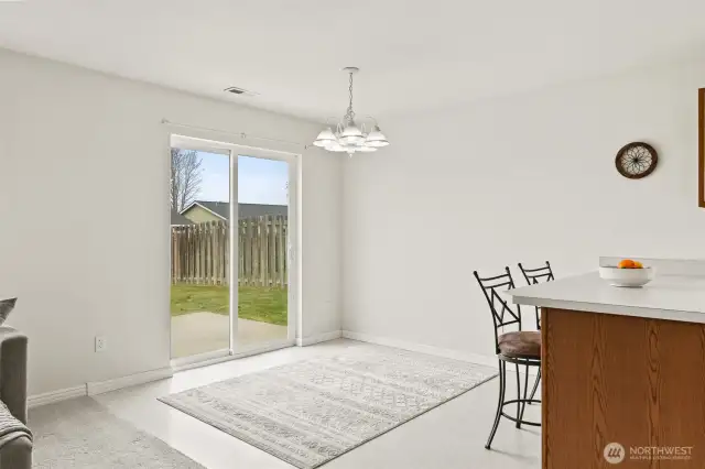 Open dining area with entrance to back yard